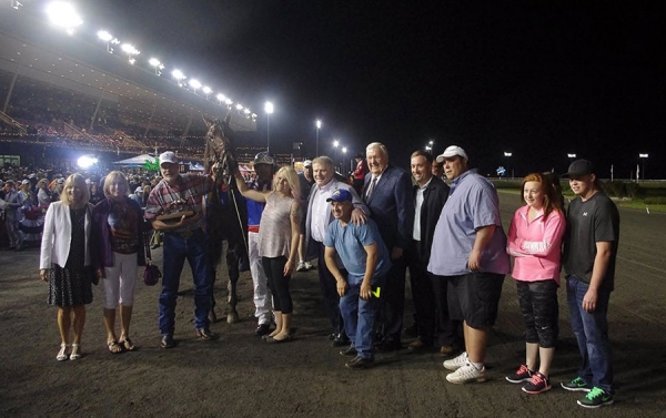 Dr. Maurice Stewart is seen holding on to Wrangler Magic and the Fan Hanover Trophy at Mohawk Racetrack on Saturday, June 20.