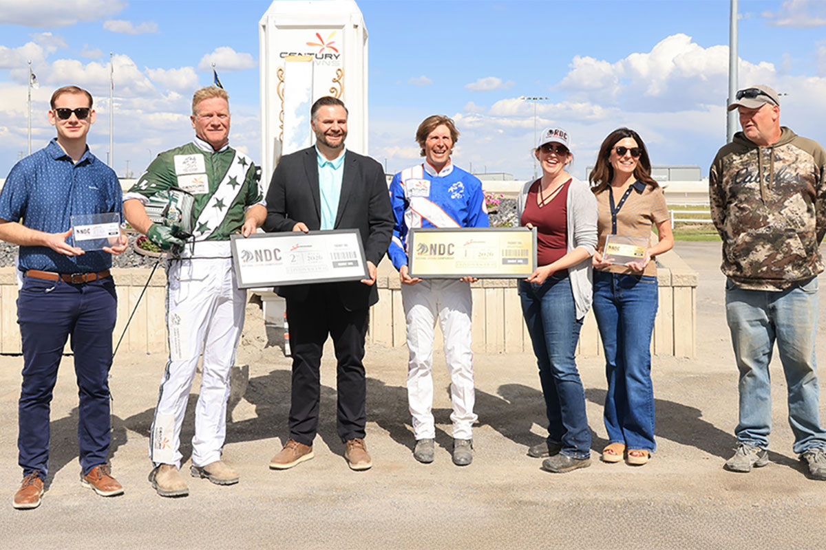 Phil Giesbrecht and Kelly Hoerdt receive their commemorative tickets to the National Driving Championship. (Left to right: Josh Murphy, Kelly Hoerdt, Allen Goodsell, Phil Giesbrecht, Dr. Jordan Cook, Nancy Retzlaff and Wally Slopiankia)